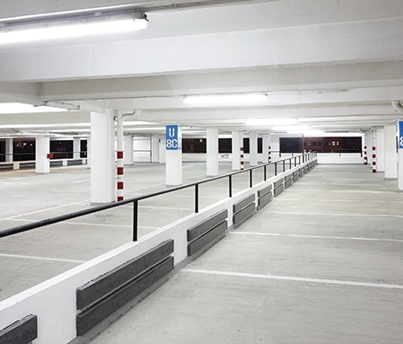 A clean indoor parking lot with dried, freshly laid concrete.