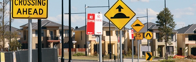 A street with multiple newly installed signs.